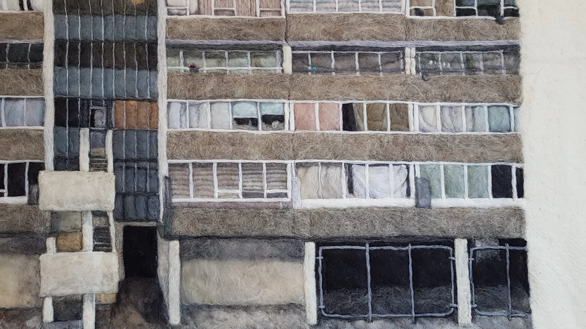 a detail of a textile piece depicting public housing