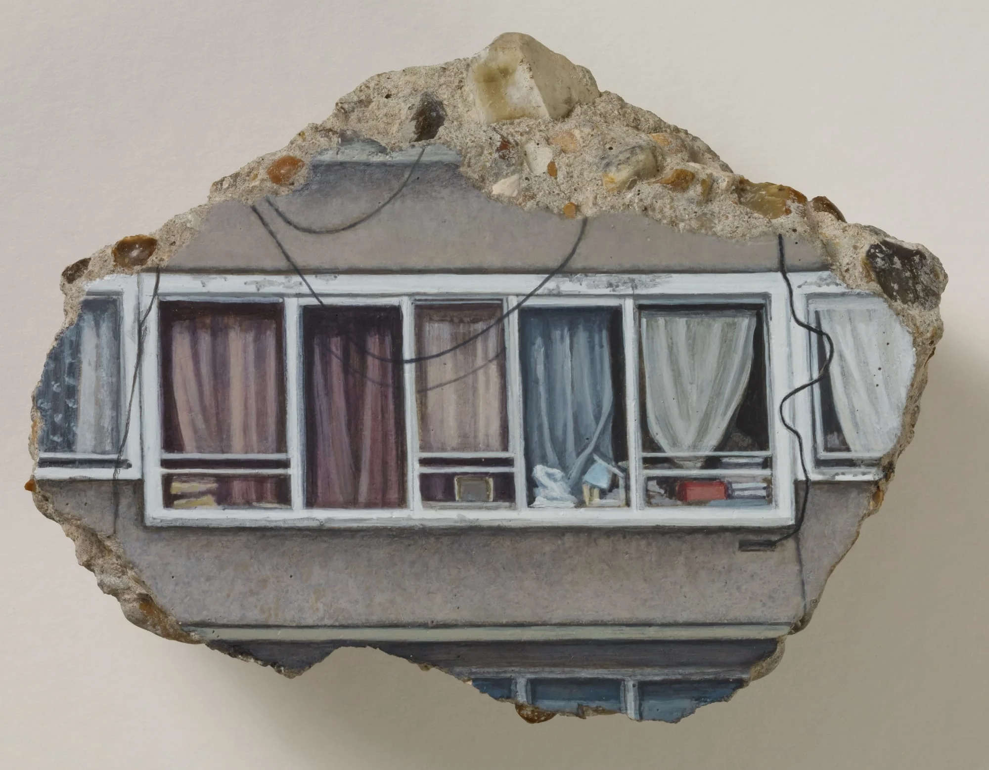 a concrete fragment with a painting of windows and curtains
